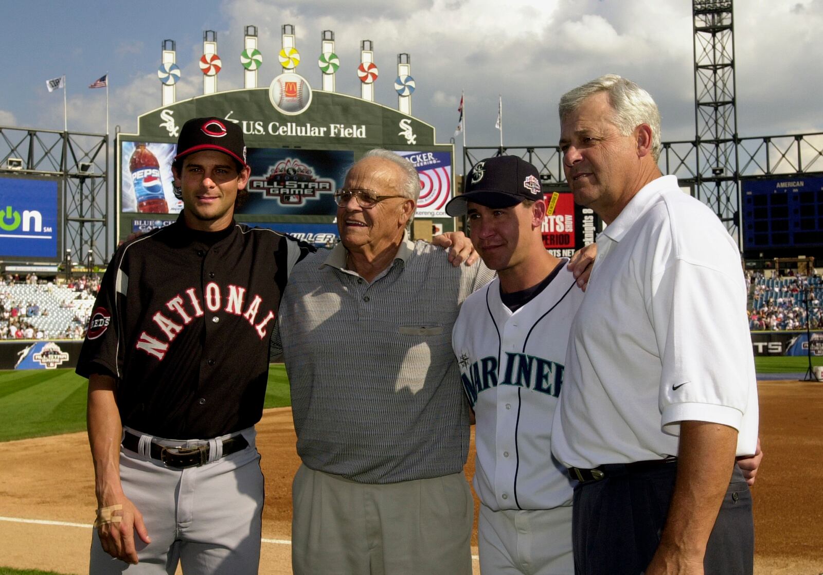 FILE - In this July 15, 2003 file photo, then-Cincinnati Reds' Aaron Boone, left, and his brother, Bret, second from right, pose with their grandfather, Ray, second from left, and father, Bob, right, before the 74th Major League Baseball All-Star Game at U.S. Cellular Field in Chicago. (AP Photo/Mark Duncan, File)