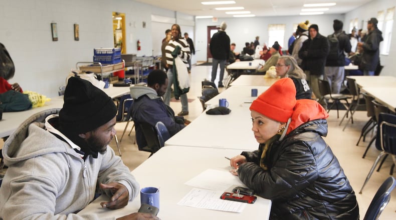 Point-in-Time Count volunteer Debra Horton, right, interviews Mickey Henry who has been sleeping in an abandoned house in Dayton. The annual count helps determine how much federal money Montgomery County receives for homeless programs. CHRIS STEWART / STAFF