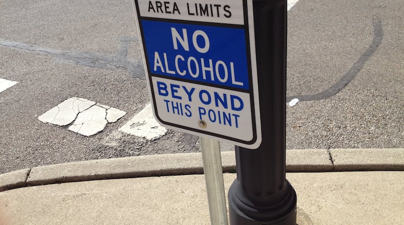 These signs are posted in the Designated Outdoor Refreshment Area in downtown Middletown where open consumption of alcoholic beverages are permitted. The city of Middletown extended the DORA district hours on Saturday for the St. Patrick’s Day celebration. FILE PHOTO