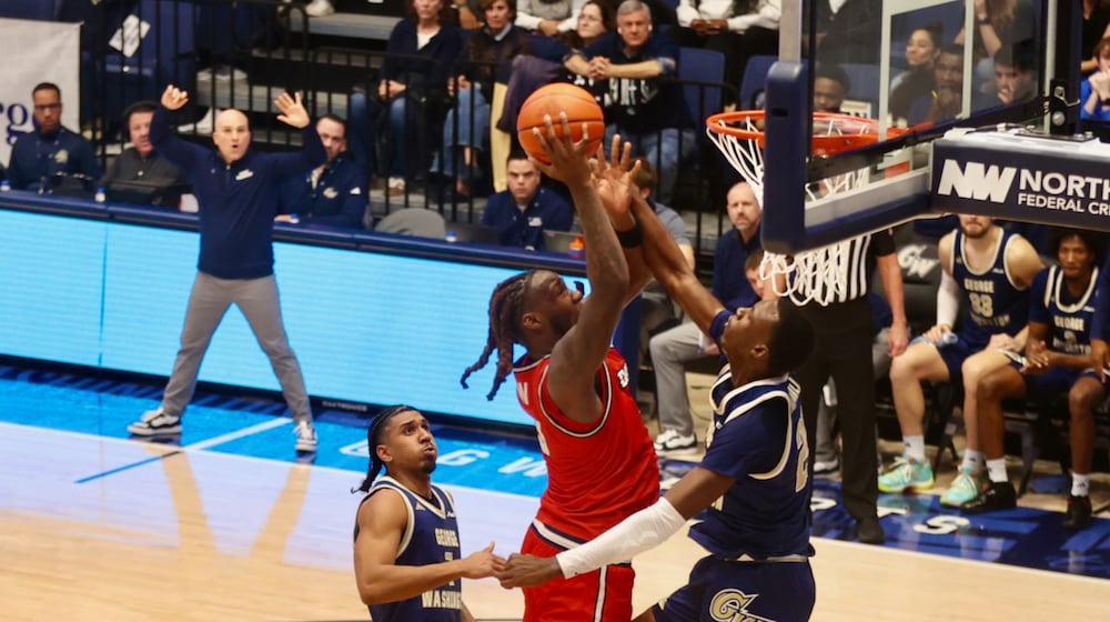 Dayton's Jaiun Simon scores in the first half against George Washington on Friday, Feb. 27, 2026, at the Charles E. Smith Center in Washington, D.C. David Jablonski/Staff