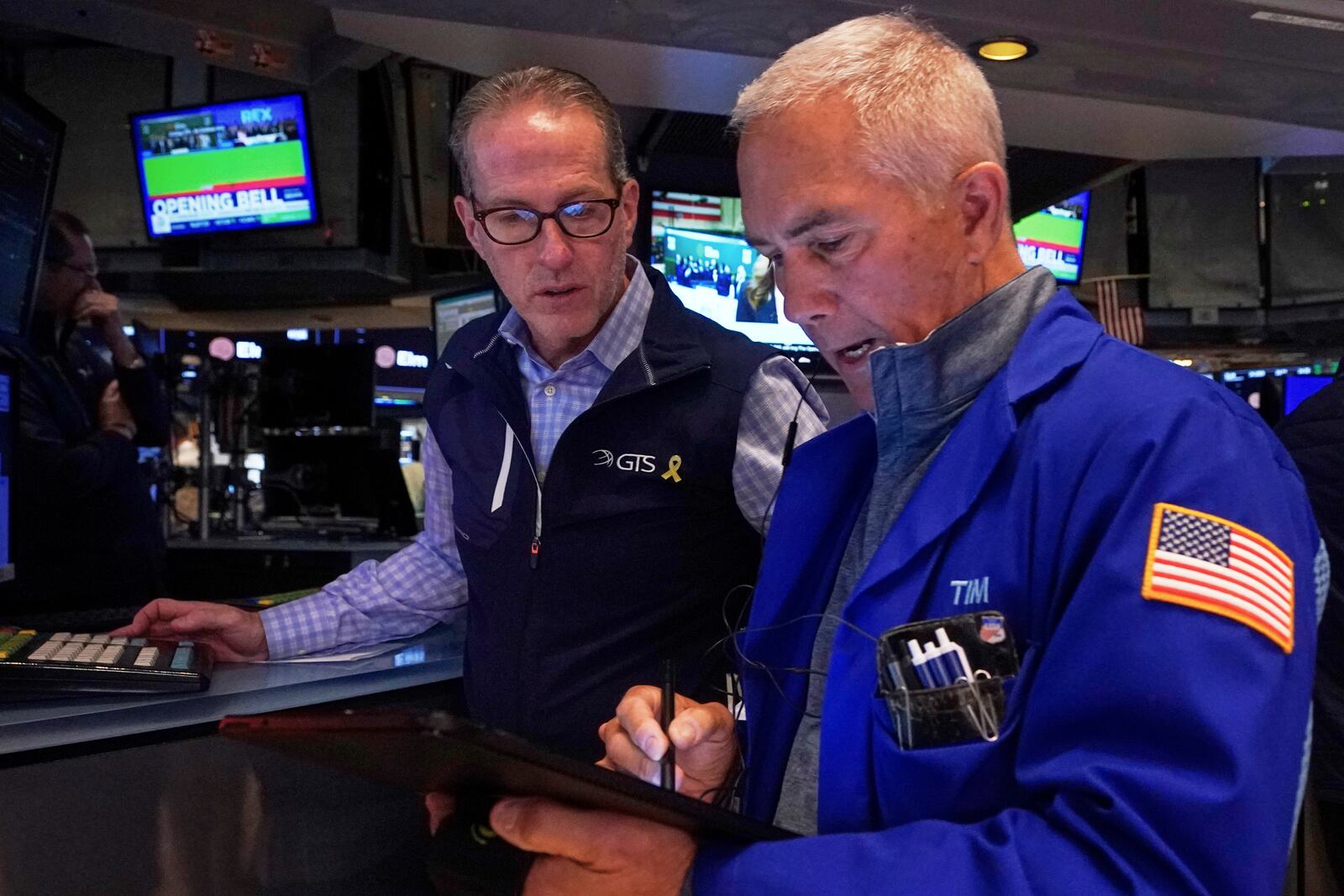 Specialist Glenn Carell, left, and trader Timothy Nick work on the floor of the New York Stock Exchange, Wednesday, April 23, 2025. (AP Photo/Richard Drew)