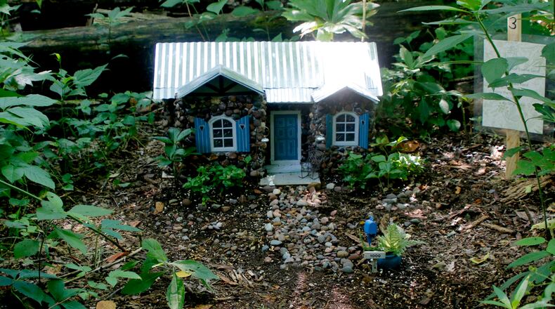 Aullwood Audubon Center Faerie House Exhibit is on display through Labor Day. The miniature homes are created from natural materials. Judi Hill, one of five volunteers to work on this year's project, features pebbles in this home's design. DAVE HILL/COURTSEY PHOTO