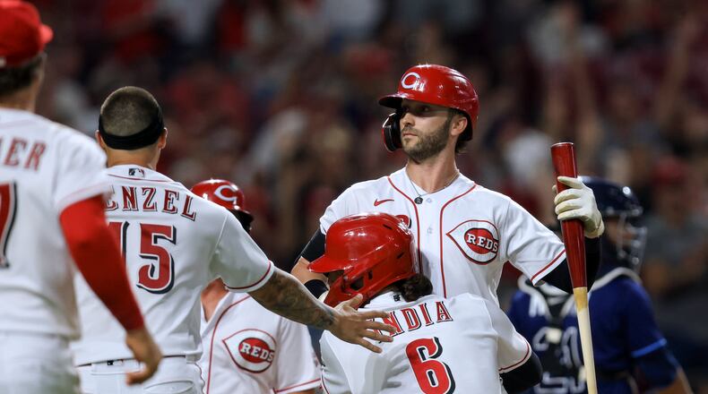 Cincinnati Reds' Tyler Naquin celebrates with teammates, including Jonathan India, after a balk by Tampa Bay Rays' Jason Adam scored the winning run during the 10th inning of a baseball game in Cincinnati, Friday, July 8, 2022. The Reds won 2-1. (AP Photo/Aaron Doster)