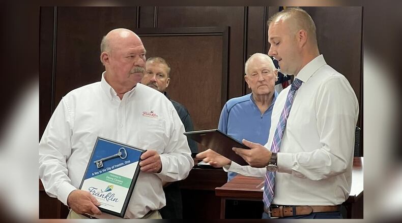 Franklin Mayor Brent Centers, right, reads a proclamation honoring Denny Centers who stepped down from his council seat Monday, Sept. 15, 2025, after 25 years in office. In back is Vice Mayor Todd Hall and Councilman Paul Ruppert. CONTRIBUTED