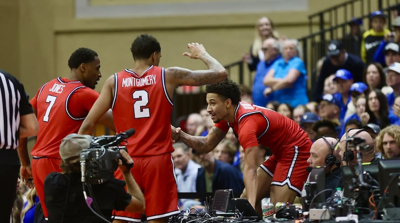 Dayton's Javon Bennett gets out of the stands after jumping after a loose ball in the second half against Brigham Young on Friday, Nov. 28, 2025, at the State Farm Field House in Kissimmee, Fla. David Jablonski/Staff