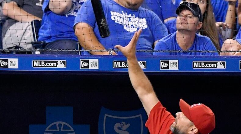 A lost bat by the Los Angeles Angels' Carlos Perez bounces off the net above the Angels' dugout in the sixth inning against the Kansas City Royals on Tuesday, July 26, 2016, at Kauffman Stadium in Kansas City, Mo. Baseball owners, managers, a couple of former players and executives had conference calls to discuss game issues, which may include the debate over whether expanded netting at ballparks should be mandatory instead of optional. (John Sleezer/Kansas City Star/TNS)
