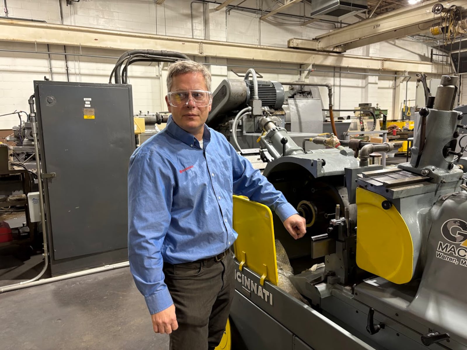 Phillip Brockman, president of Techmetals Inc., demonstrates the use of a centerless grinding machine at one of his Springfield Street plants. He expects revenue growth of 8% to 10% this year. THOMAS GNAU/STAFF