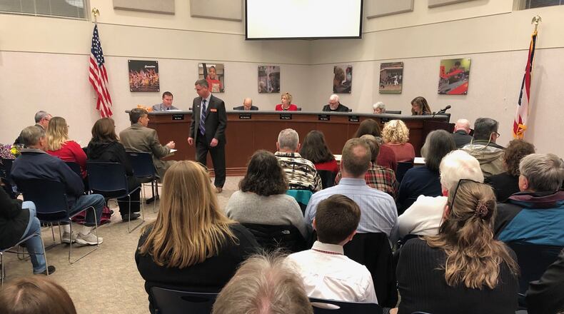 Beavercreek’s school board met before a packed room in February and approved $2.6 million in budget cuts for the 2019-20 school year. JEREMY P. KELLEY / STAFF