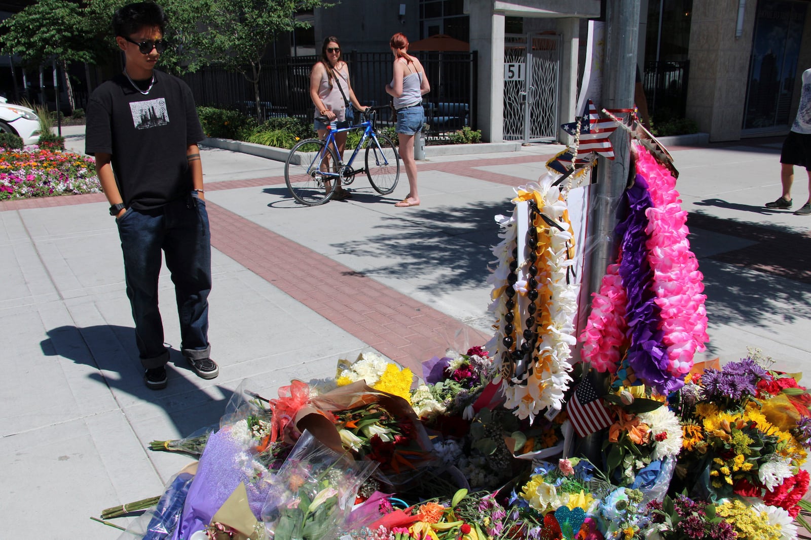 A young man pays his respects to Arthur Folasa Ah Loo, known to friends and family as Afa, Tuesday, June 17, 2025, at a makeshift memorial in Salt Lake City, Utah, on the block where Ah Loo was fatally shot during a "No Kings" protest on Saturday, June 14. (AP Photo/Hannah Schoenbaum)