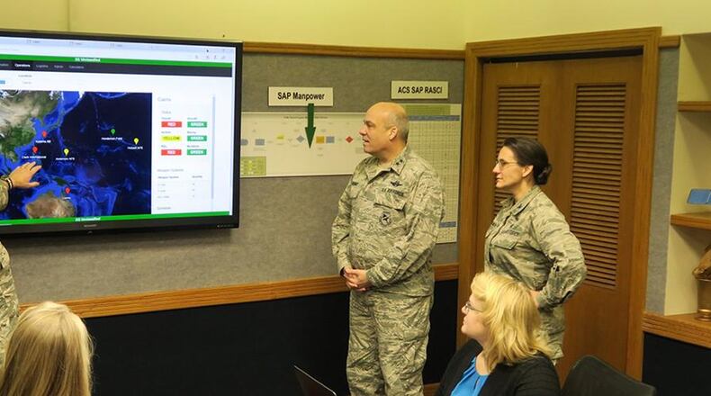 (From left to right) Maj. Nick Kirsch, Maj. Gen. Michael Brewer and Col. Francesca Bartholomew, of Air Force Materiel Command, review an analysis from an Integrated Sustainment Wargaming Analysis Toolkit (ISWAT) scenario. Frontier Technology helped develop the ISWAT technology. (U.S. Air Force photo)
