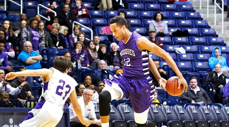 Middletown's Vincent Edwards (12) fakes out Elder's Joey Sabato (23) during a 2014 Division I sectional boys basketball game. Middletown defeated Elder 54-47.