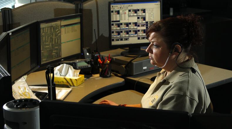 Civilian diispatcher Denise Steele works at the Montgomery County Regional Dispatch Center. Capt. Matt Haines, commander of the dispatch center, said strict training requirements and high turnover feed unavoidably steep overtime costs for his office. LISA POWELL / STAFF