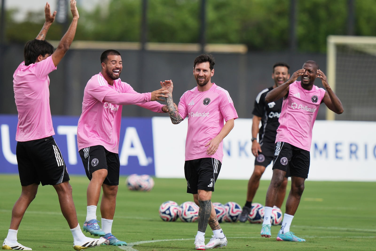 Inter Miami forward Lionel Messi, third from left, jokes with his teammates during a training session Friday, June 13, 2025, in Fort Lauderdale, Fla. in preparation for a Club World Cup soccer match Saturday. (AP Photo/Lynne Sladky)