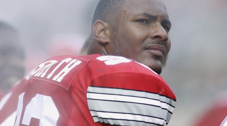COLUMBUS, OH - AUGUST 24: Defensive end Will Smith #93 of the Ohio State Buckeyes sits on the bench during the NCAA Pigskin Classic against the Texas Tech Red Raiders on August 24, 2002 at Ohio Stadium in Columbus, Ohio. Ohio State defeated Texas Tech 45-21. (Photo by Mark Lyons/Getty Images)