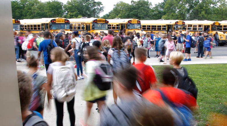 Miamisburg Middle School students head for the buses at the end of a schools day. TY GREENLEES / STAFF