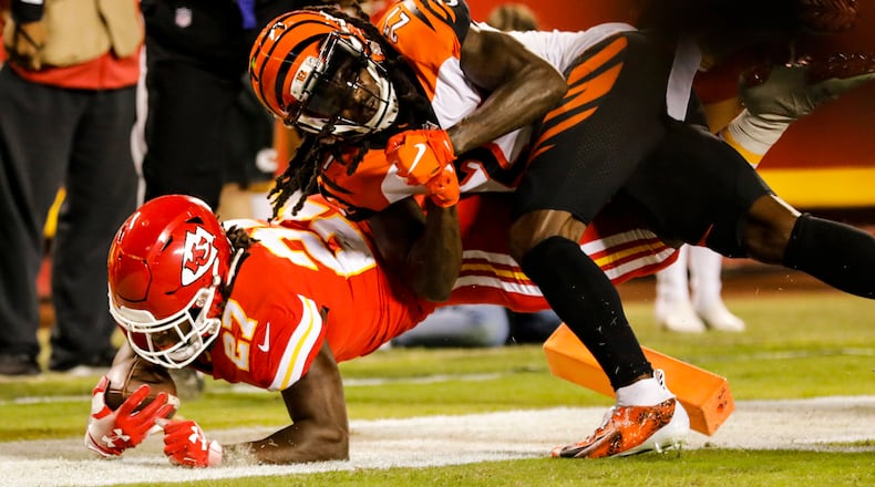 KANSAS CITY, MO - OCTOBER 21: Kareem Hunt #27 of the Kansas City Chiefs crosses over the goal line scoring the games first touchdown through the tackle attempt of Dre Kirkpatrick #27 of the Cincinnati Bengals in the first quarter at Arrowhead Stadium on October 21, 2018 in Kansas City, Kansas. (Photo by David Eulitt/Getty Images)