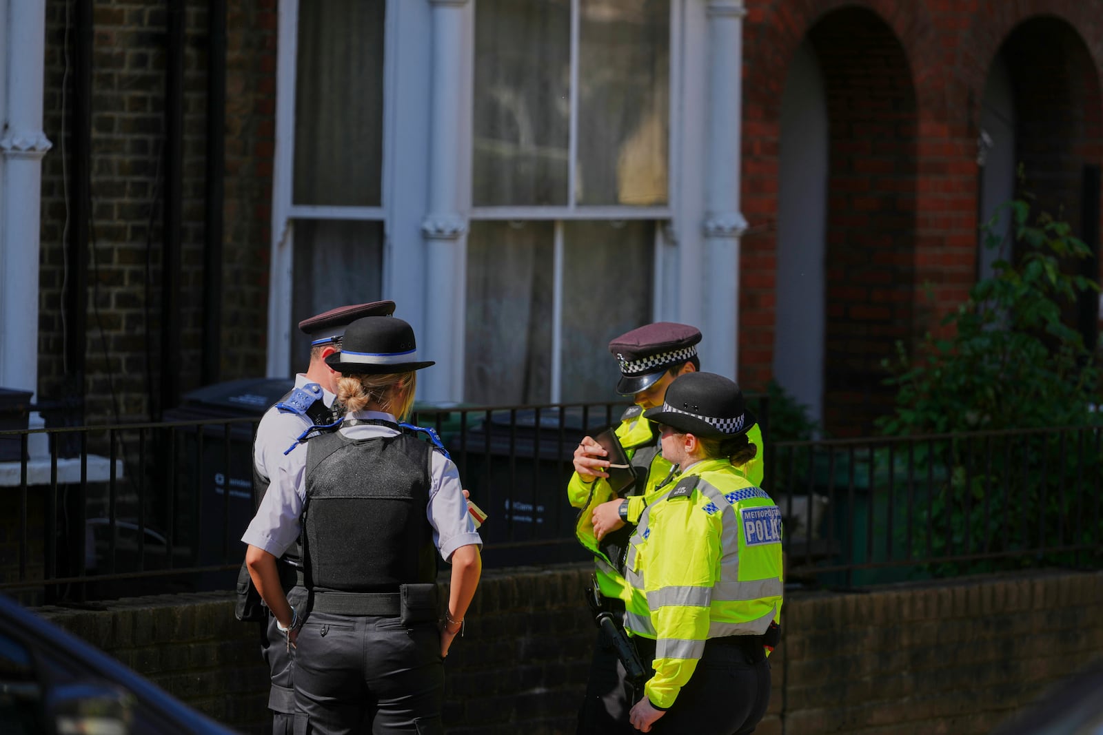 Police Community Support Officers and Police Officers stand on the street near a house belonging to British Prime Minister Keir Starmer at Kentish Town in London, Tuesday, May 13, 2025. (AP Photo/Kirsty Wigglesworth)