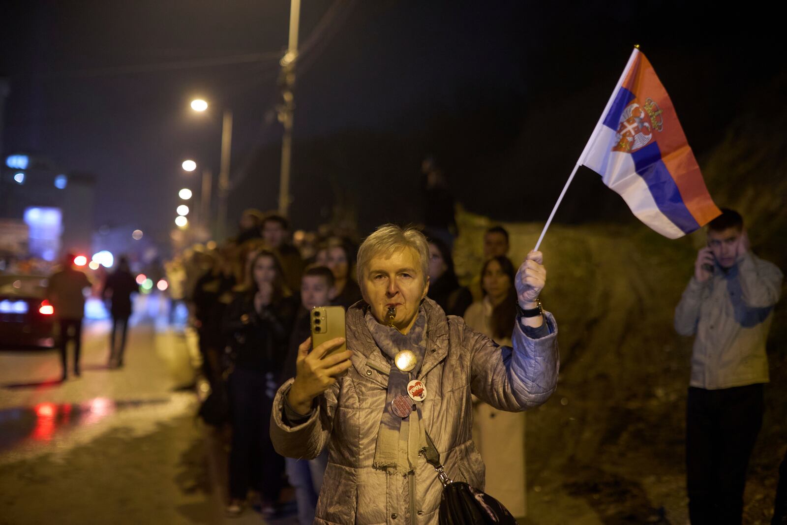 A woman welcomes a group of students who walked across the country arrive at an anti-corruption protest in the southwestern town of Novi Pazar, Serbia, Friday, April 11, 2025. (AP Photo/Marko Drobnjakovic)