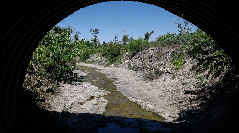 This waterway in Harrison Twp. between Main St. and the Stillwater River is approved to receive USDA Natural Resources Conservation Service grants to remove tree debris from the Memorial Day tornados in 2019. JIM NOELKER/STAFF