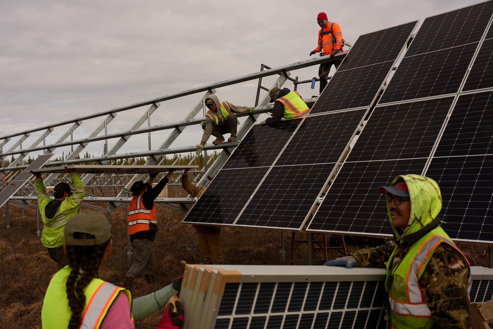 FILE - Workers install panels at a solar project May 21, 2025, in Galena, Alaska. (AP Photo/John Locher, File)