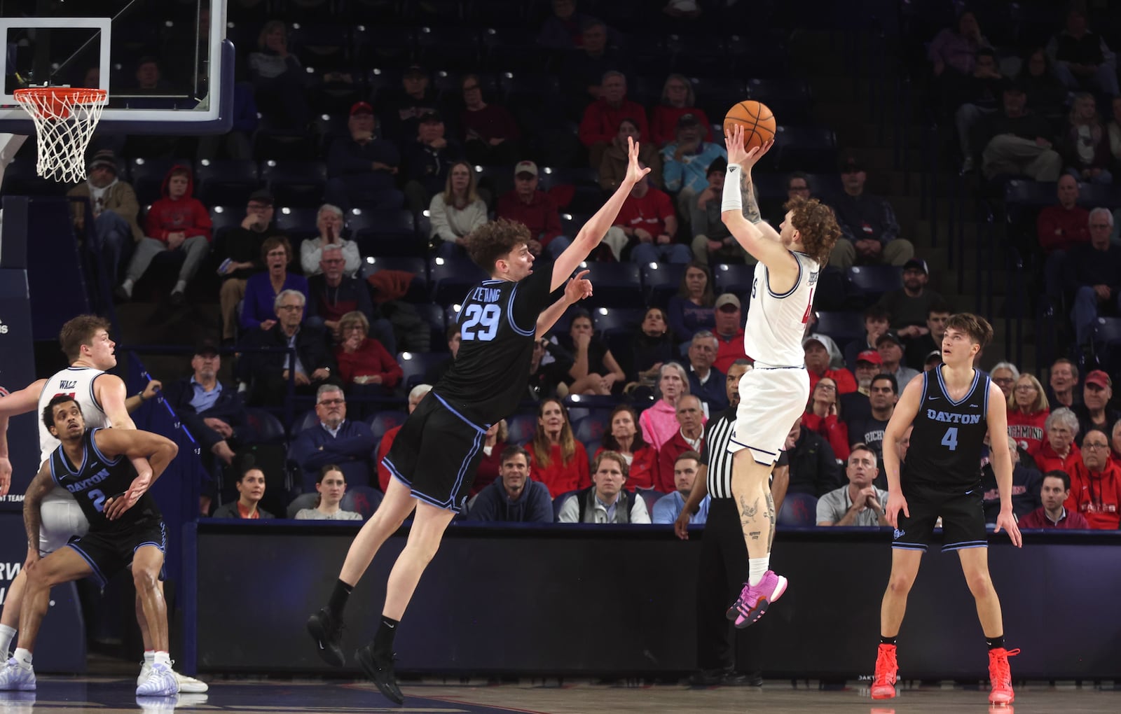 Richmond's Will Johnston makes a game-tying shot in front of Dayton's Amaël L'Etang in the final minutes on Tuesday, March 3, 2026, at the Robins Center in Richmond, Va. David Jablonski/Staff