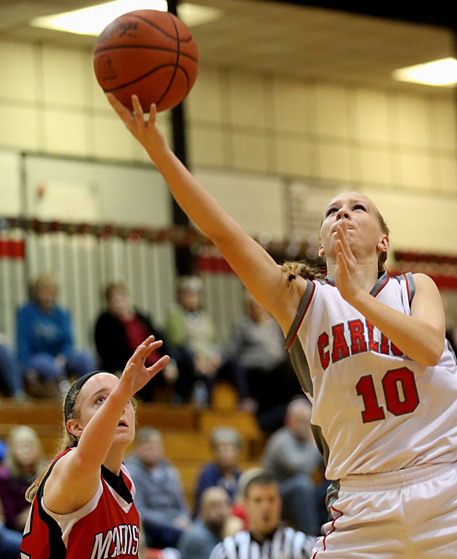 Carlisle guard Christa Harris gets past Madison’s Lily Campbell to score two of her 15 points during Saturday afternoon’s game at Carlisle. CONTRIBUTED PHOTO BY E.L. HUBBARD