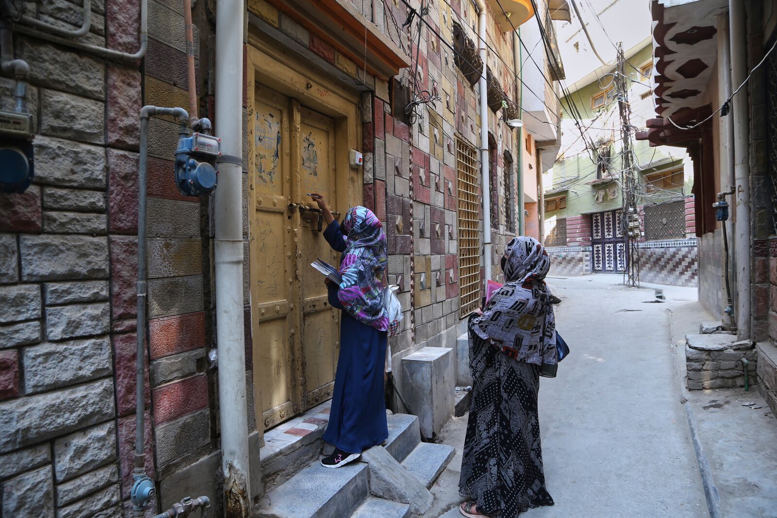 A health worker marks a house after administrating a polio vaccine to a child at a neighborhood in Peshawar, Pakistan, Monday, May 26, 2025. (AP Photo/Muhammad Sajjad)