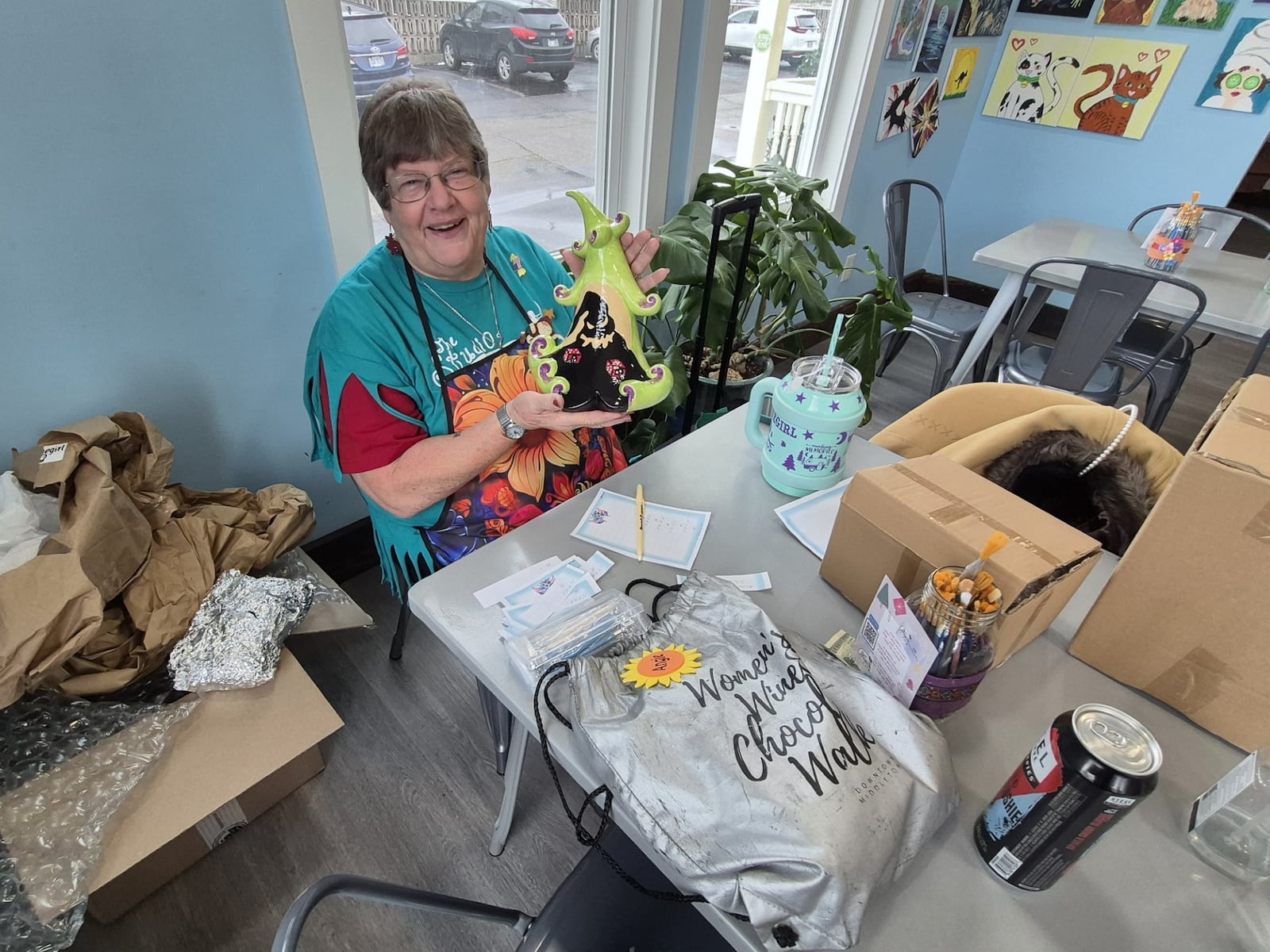 Angie Buettner shows off her work at The Studio in Hamilton. the art shop has a variety of packages that make great experiential gifts. MICHAEL KURTZ / STAFF