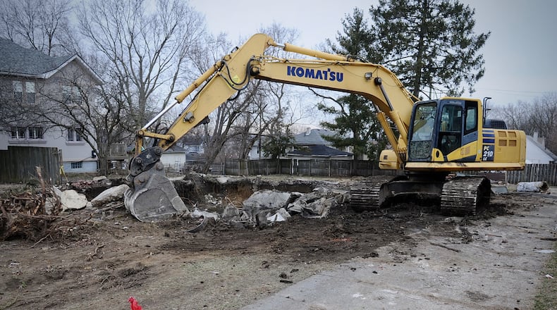 Crews excavating a torn down house in the 1300 block of Huffman Avenue in Dayton found a body in the basement, police said. MARSHALL GORBY \STAFF