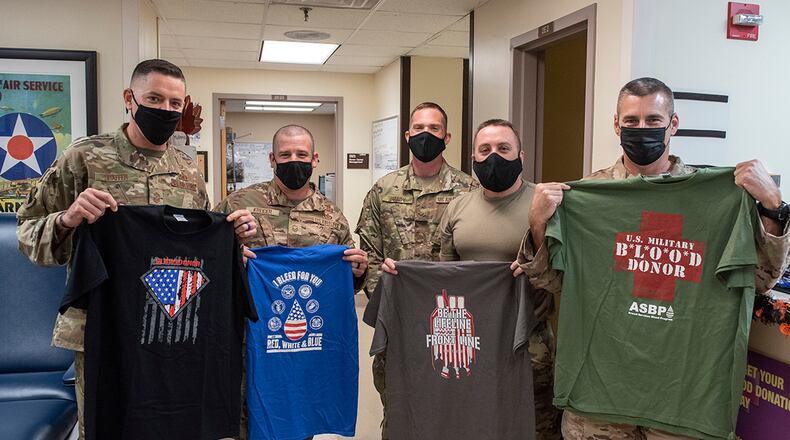 Chief Master Sgt. Jason Shaffer (far left), 88th Air Base Wing command chief, poses with other senior NCOs after they donated blood Oct. 19 at Wright-Patterson Air Force Base. Blood collected by Wright-Patterson Medical Center goes to the Armed Services Whole Blood Processing Laboratory in New Jersey to help service members around the world. U.S. AIR FORCE PHOTO/WESLEY FARNSWORTH