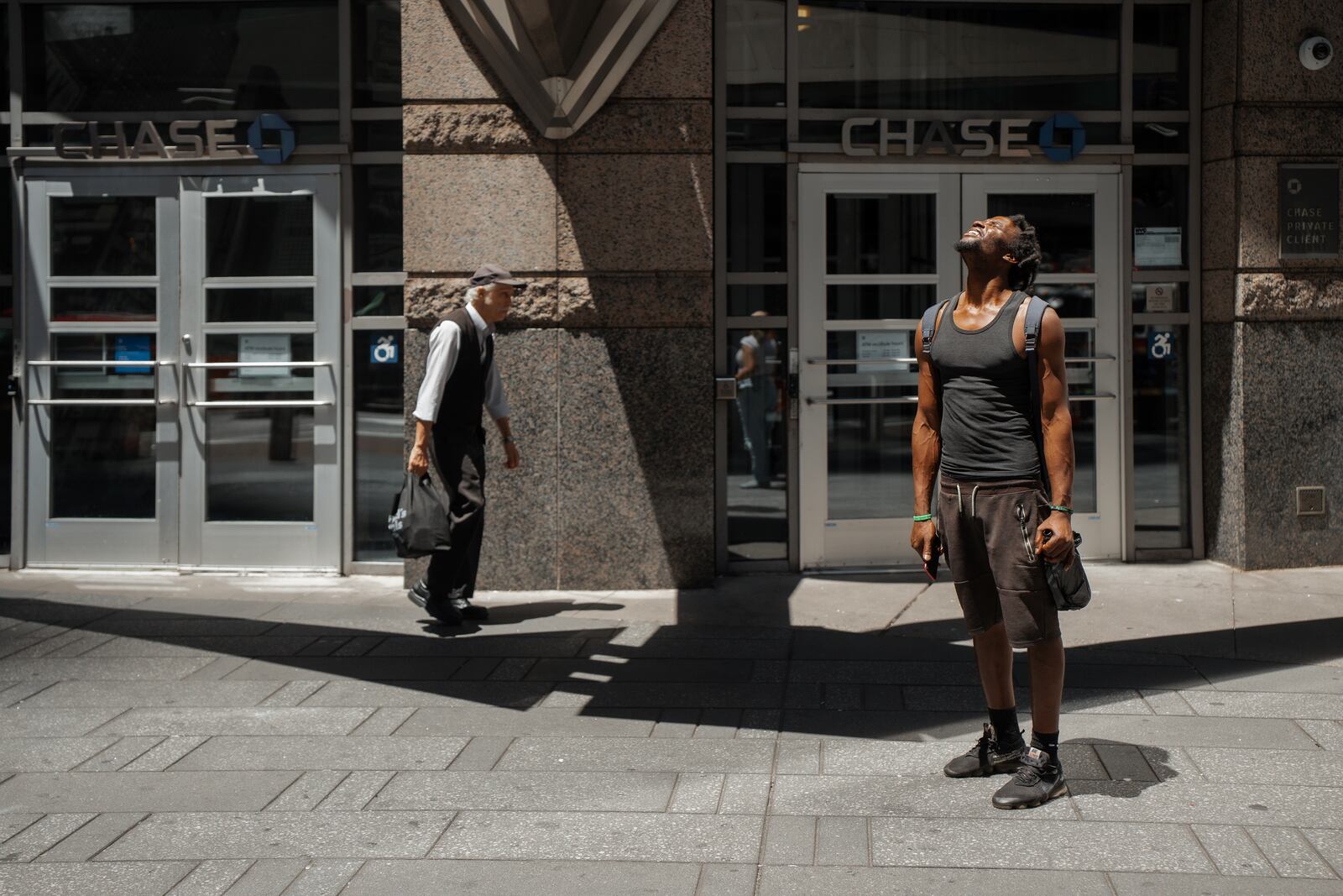A man squints at the sun during a heatwave on Tuesday, June 24, 2025, in New York. (AP Photo/Olga Fedorova)