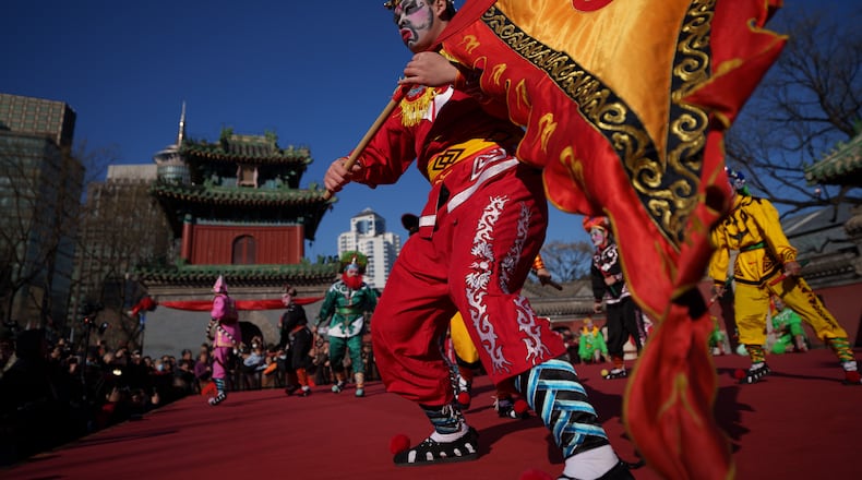 Dancers in colorful costumes perform Yingge Dance, a traditional folk dance from southern China during Lunar New Year celebrations in Beijing, China, Tuesday, Feb. 17, 2026. (AP Photo/Vincent Thian)