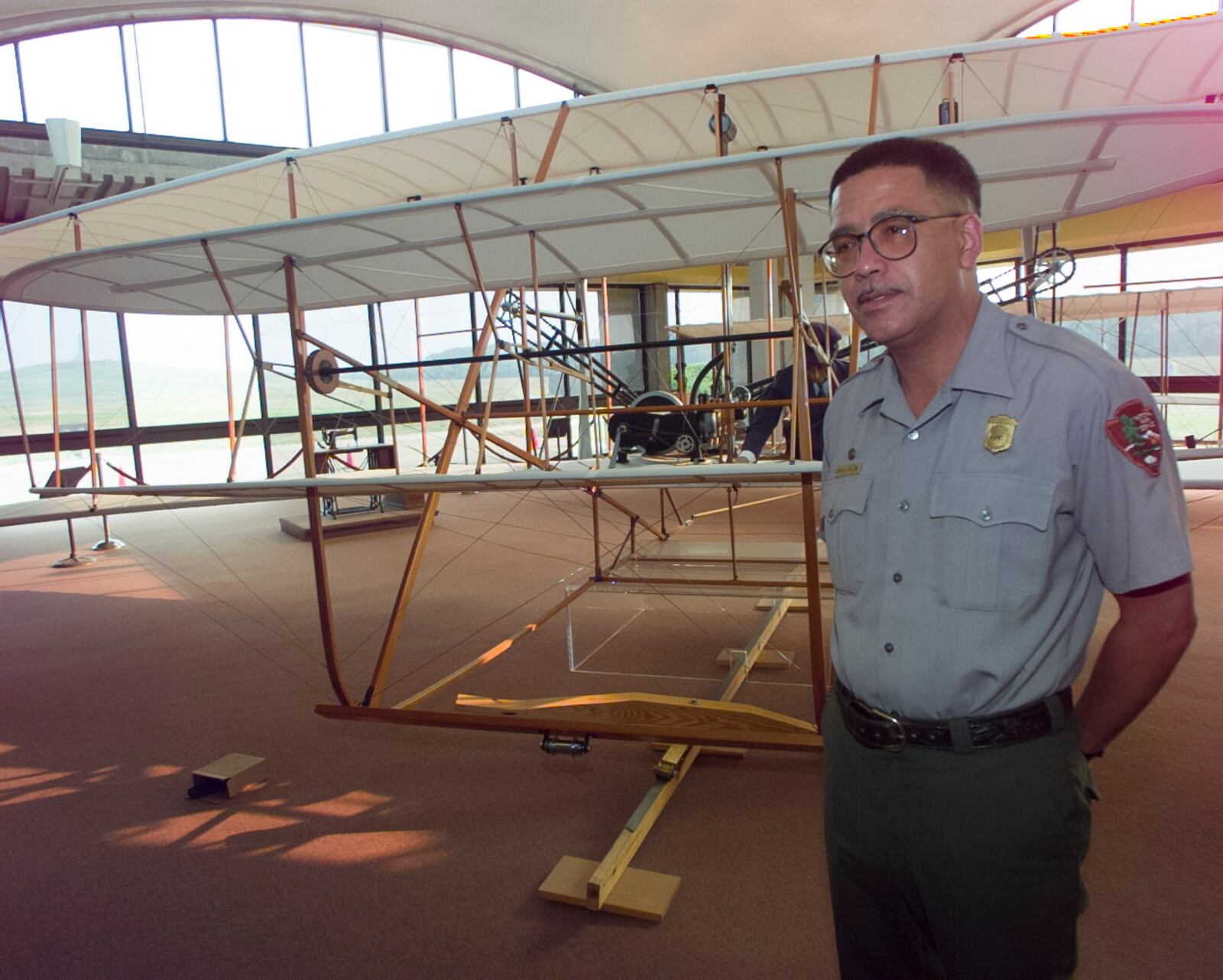 Wright Brothers National Memorial Park Ranger and Historian Daryl Collins with a Wright Flyer replica at Kill Devil Hills, North Carolina. 1997