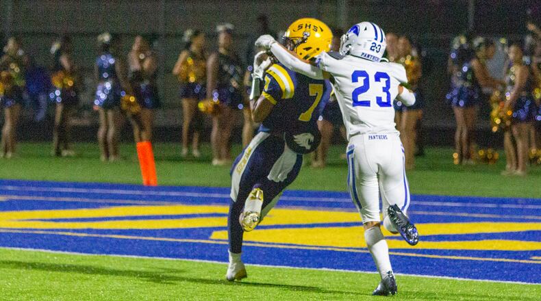 Springfield's Anthony Brown catches his second long touchdown pass in front of Springboro's Wyatt Standifer during the first half of Friday's game at Springfield. CONTRIBUTED/Jeff Gilbert
