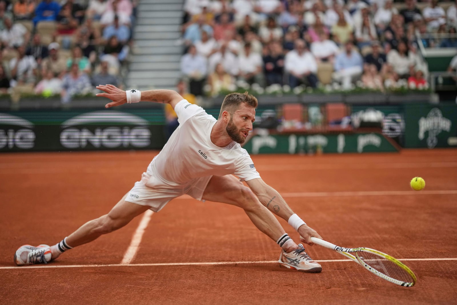 France's Corentin Moutet reaches for the ball as he plays Serbia's Novak Djokovic during their second round match of the French Tennis Open, at the Roland-Garros stadium, in Paris, Thursday, May 29, 2025. (AP Photo/Christophe Ena)