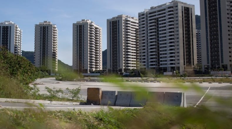 In this July 16, 2017 photo, an empty parking lot is seen in front of the Athlete's Village, in Rio de Janeiro, Brazil. More than 3,600 apartments remain unoccupied. (AP Photo/Renata Brito)