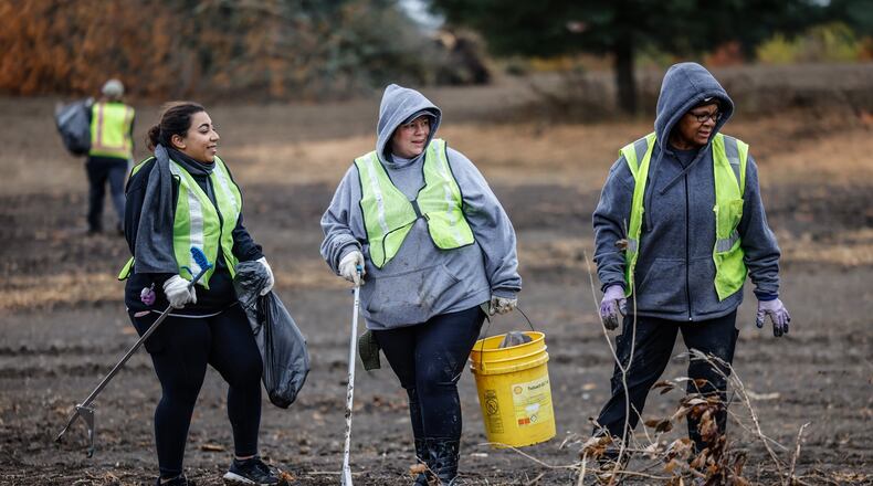 About 19 volunteers from AES Ohio picked up debris from the old Larch Tree Golf Course that is now the Spring Run Conservation Area Wetland Wednesday, Oct. 26, 2022. Five Rivers MetroParks plans to restore 22 acres of wetlands. The project is part of the state's H2Ohio program, which aims to improve water quality and infrastructure. JIM NOELKER/STAFF
