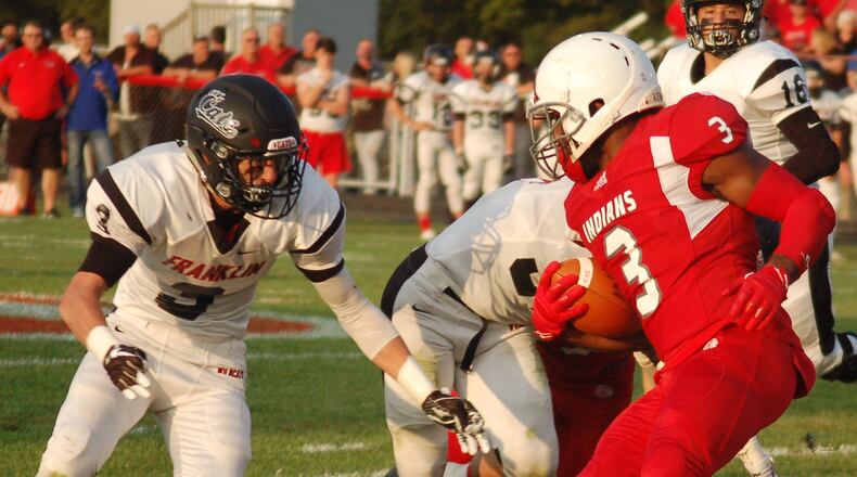 Franklin’s Kyle Rickard moves in to tackle Carlisle’s DJ Chambers during Friday night’s season opener at Carlisle. Franklin won 47-14. JOHN CUMMINGS/CONTRIBUTED PHOTO