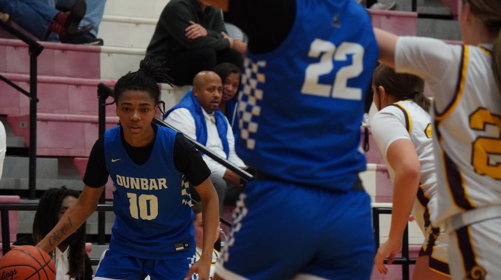 Dunbar’s Donisha Davis dribbles the ball against Ross on Saturday at Fairfield Arena. CHRIS VOGT / CONTRIBUTED