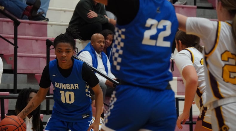 Dunbar’s Donisha Davis dribbles the ball against Ross on Saturday at Fairfield Arena. CHRIS VOGT / CONTRIBUTED