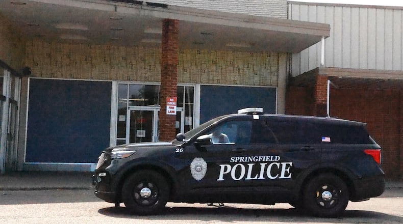 A Springfield police officer sits outside the closed Ohio BMV in the Southern Village Shopping Center Friday, Sept. 13, 2024. BILL LACKEY/STAFF