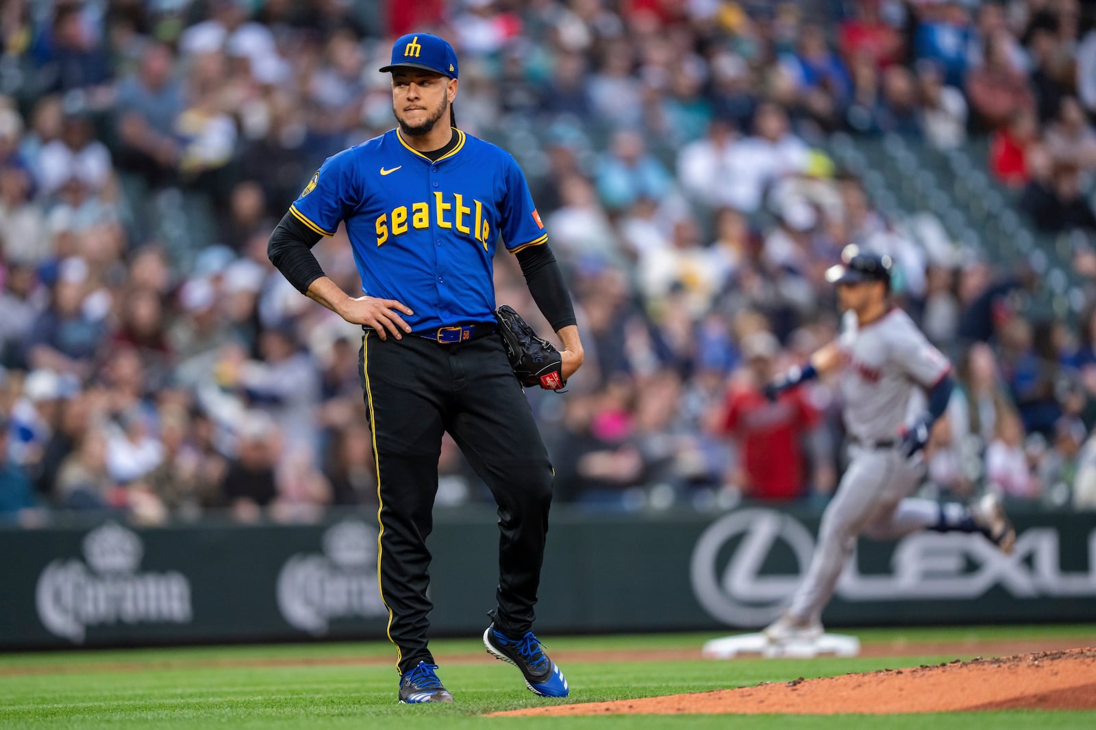 Seattle Mariners starting pitcher Luis Castillo, left, reacts after giving up back-to-back home runs during the third inning of a baseball game against the Cleveland Guardians, Friday, June 13, 2025, in Seattle. (AP Photo/Stephen Brashear)