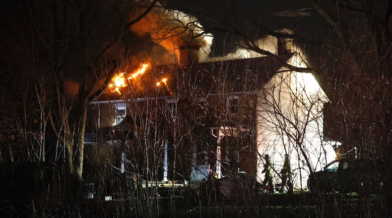 Firefighters from several area departments responded to a two story farm house fire on Taylorsville Road in Huber Heights Friday evening March 1, 2024. BILL LACKEY/STAFF