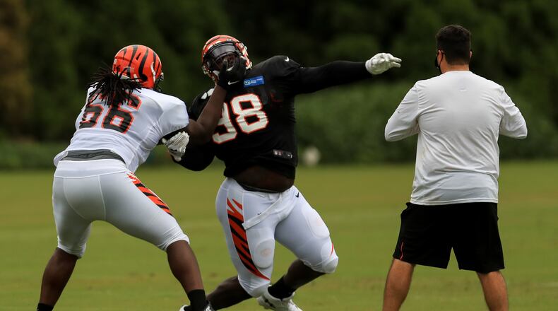Cincinnati Bengals' Trey Hopkins (66) battles against D.J. Reader (98) during an NFL football camp practice in Cincinnati, Tuesday, Aug. 18, 2020. (AP Photo/Aaron Doster)