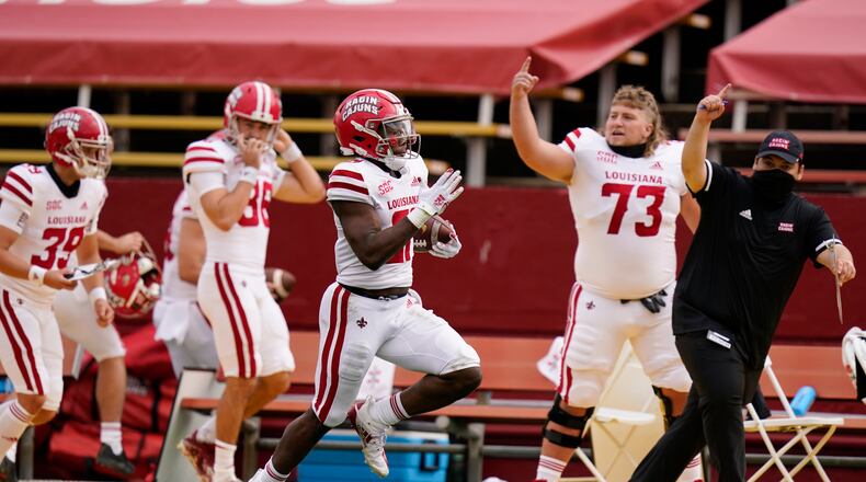Louisiana-Lafayette running back Chris Smith, center, returns a kickoff 95-yards for a touchdown during the first half of an NCAA college football game against Iowa State, Saturday, Sept. 12, 2020, in Ames, Iowa. (AP Photo/Charlie Neibergall)