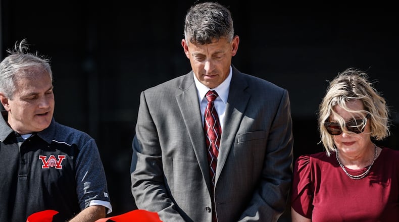 From left, Mark Combs, Jason Enix and Shannon Weldon cut the ribbon on the new Wayne High School Career Tech Center Thursday August 10, 2023, JIM NOELKER/STAFF