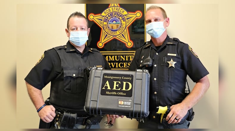 Montgomery County Sheriff's deputies Gust Teague, left, and Brandon Baker, right, used a defibrillator to help save the life of a utility worker who suffered an electric shock Sept. 9, 2020, while working on power lines in the backyard of a Jefferson Twp. home.