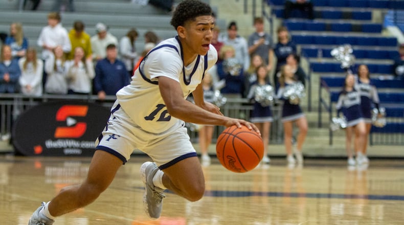 Fairmont's Anthony Johnson looks for a driving lane Monday night against Cincinnati Woodward in the Flyin' To The Hoop finale at Trent Arena. Jeff Gilbert/CONTRIBUTED