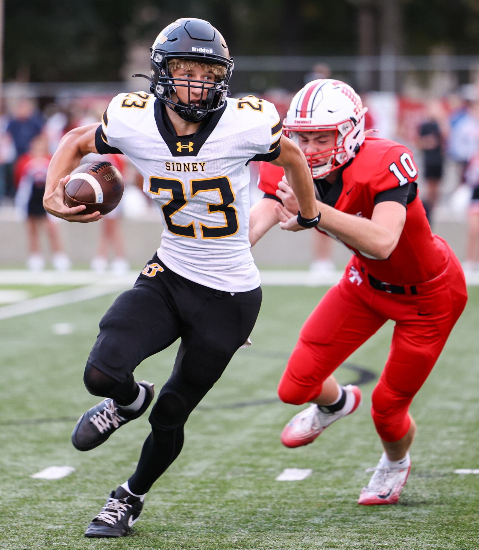 Sidney freshman quarterback Andrew Lundy tries to avoid Tippecanoe's Bryton Otto during a Miami Valley League game on Thursday, Sept. 25 at City Park in Tipp City. BRYANT BILLING / STAFF