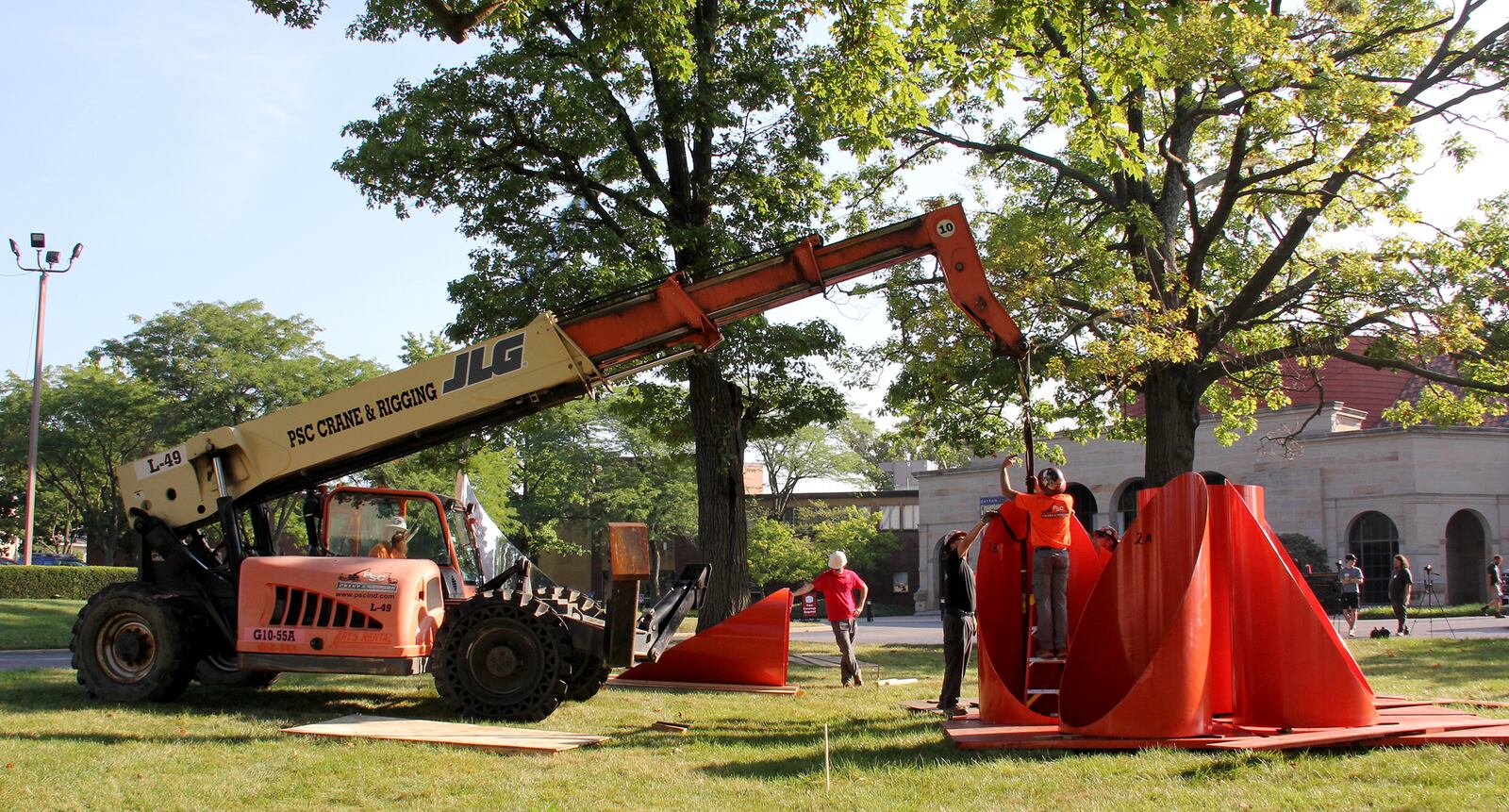 “Firmament,” the bright orange sculpture of steel cylinders on the Dayton Art Institute grounds, was removed Monday, Aug. 23 for conservation work. The artwork, created by Alexander Liberman, has been part of the museum’s collection since 1976. It will be returned in November. ERIC BROCKMAN / DAYTON ART INSTITUTE